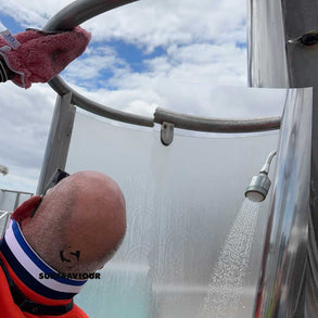 Ship Cleaning Operative cleans the dirt, grease and limescale from the steel fixtures of a pool-side shower
