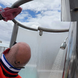 Ship Cleaning Operative cleans the dirt, grease and limescale from the steel fixtures of a pool-side shower